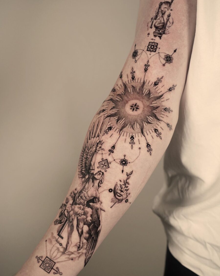 Eye-catching biceps tattoo with sun and phoenix Tattoo on skin