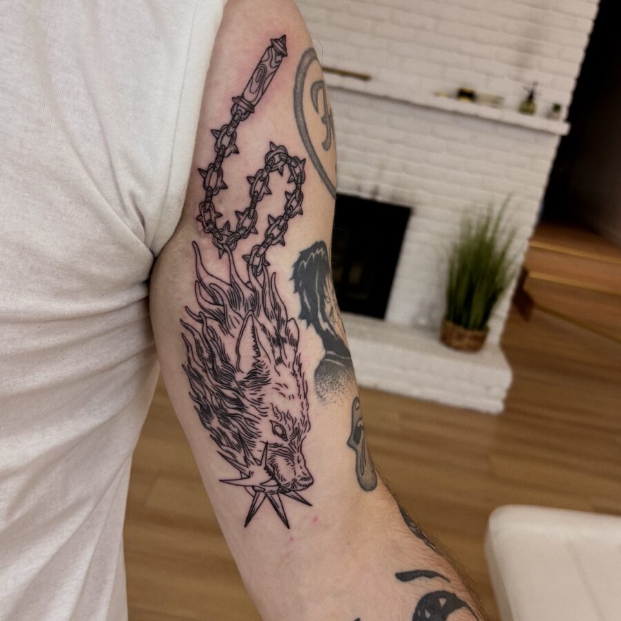 Fiery fox tattoo design on bicep. Tattoo on skin