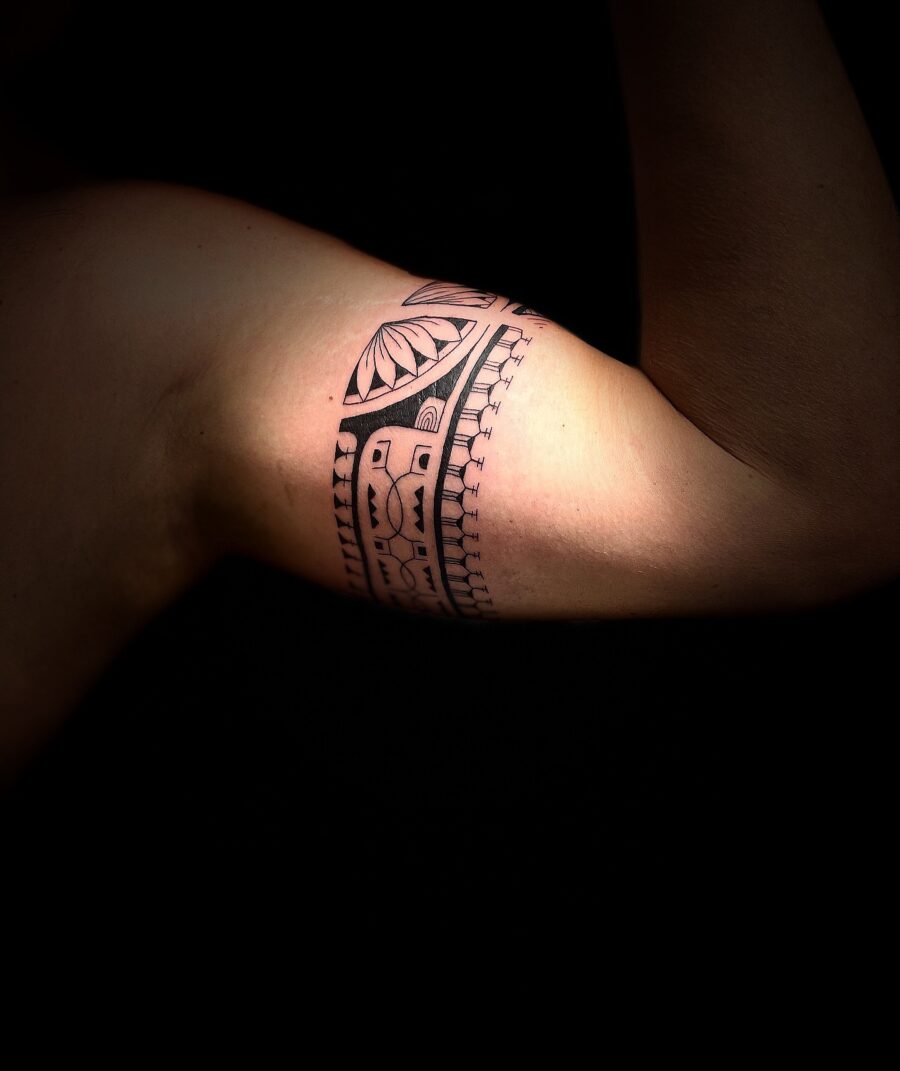 Intricate tribal design adorns bicep Tattoo on skin