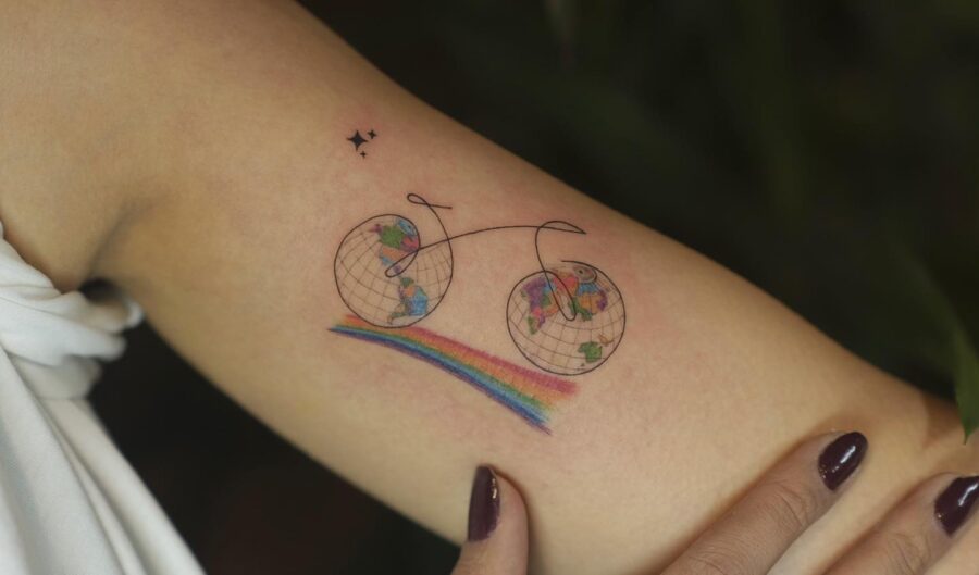 Whimsical bike tattoo with rainbow accents Tattoo on skin