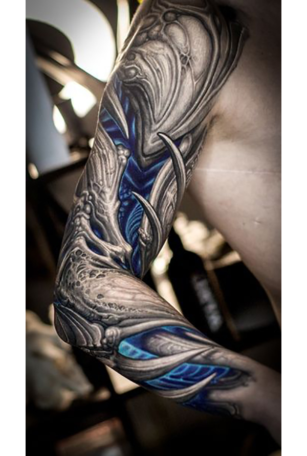 Black and White Biomechanical Tattoo with Blue Tattoo on skin