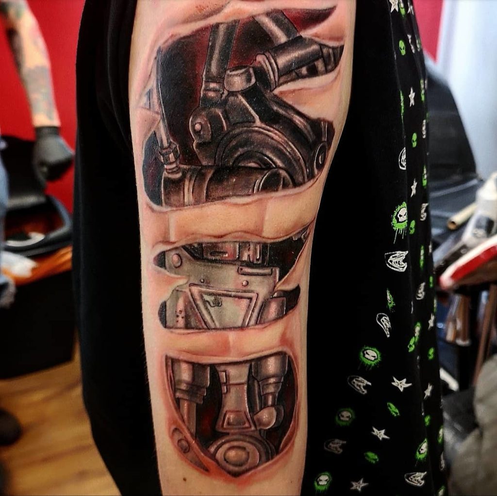 Ripped Skin Biomechanical Tattoo on Arm Tattoo on skin
