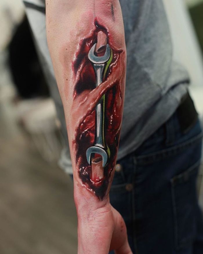 Wrench as Arm Bone Colored Biomechanical Tattoo Tattoo on skin