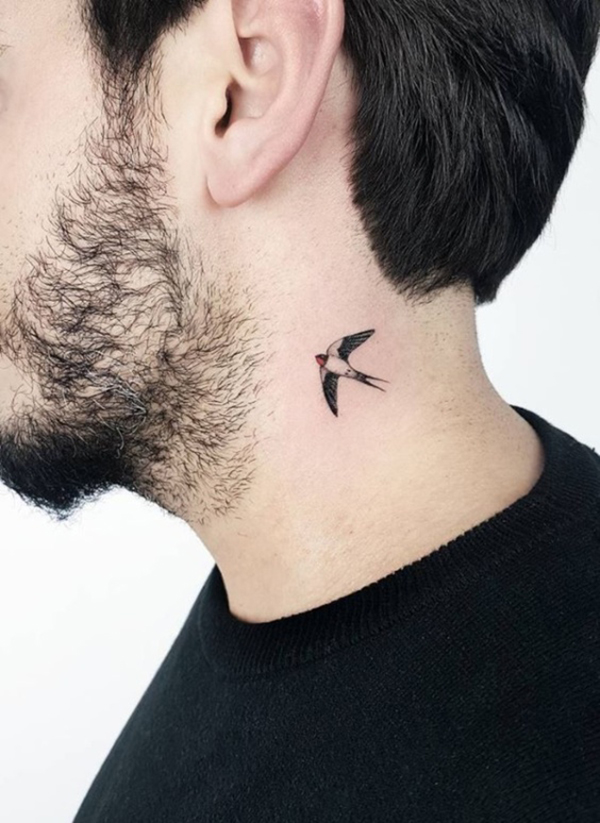 Small Swallow Tattoo Behind the Ear Tattoo on skin