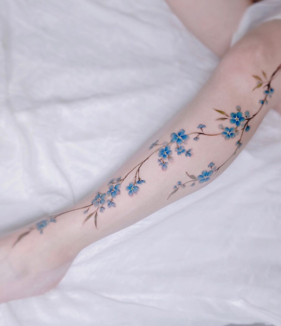 Beautiful blue flower tattoo on the arm Tattoo on skin