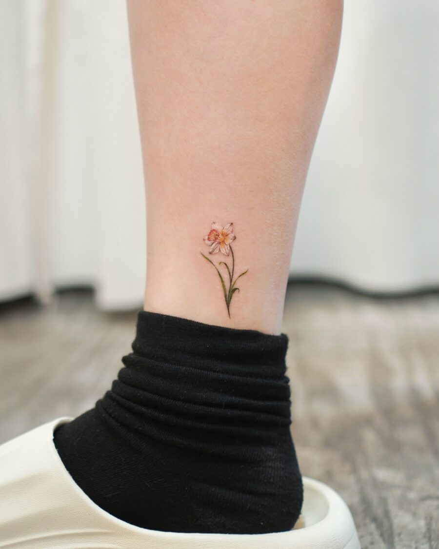 Charming birth flower tattoo on elegant ankle Tattoo on skin
