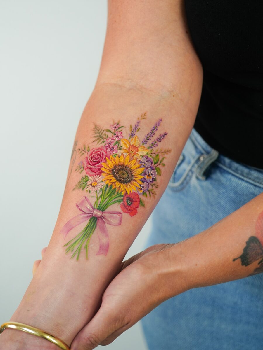 Colorful bouquet tattoo with vibrant blossoms Tattoo on skin
