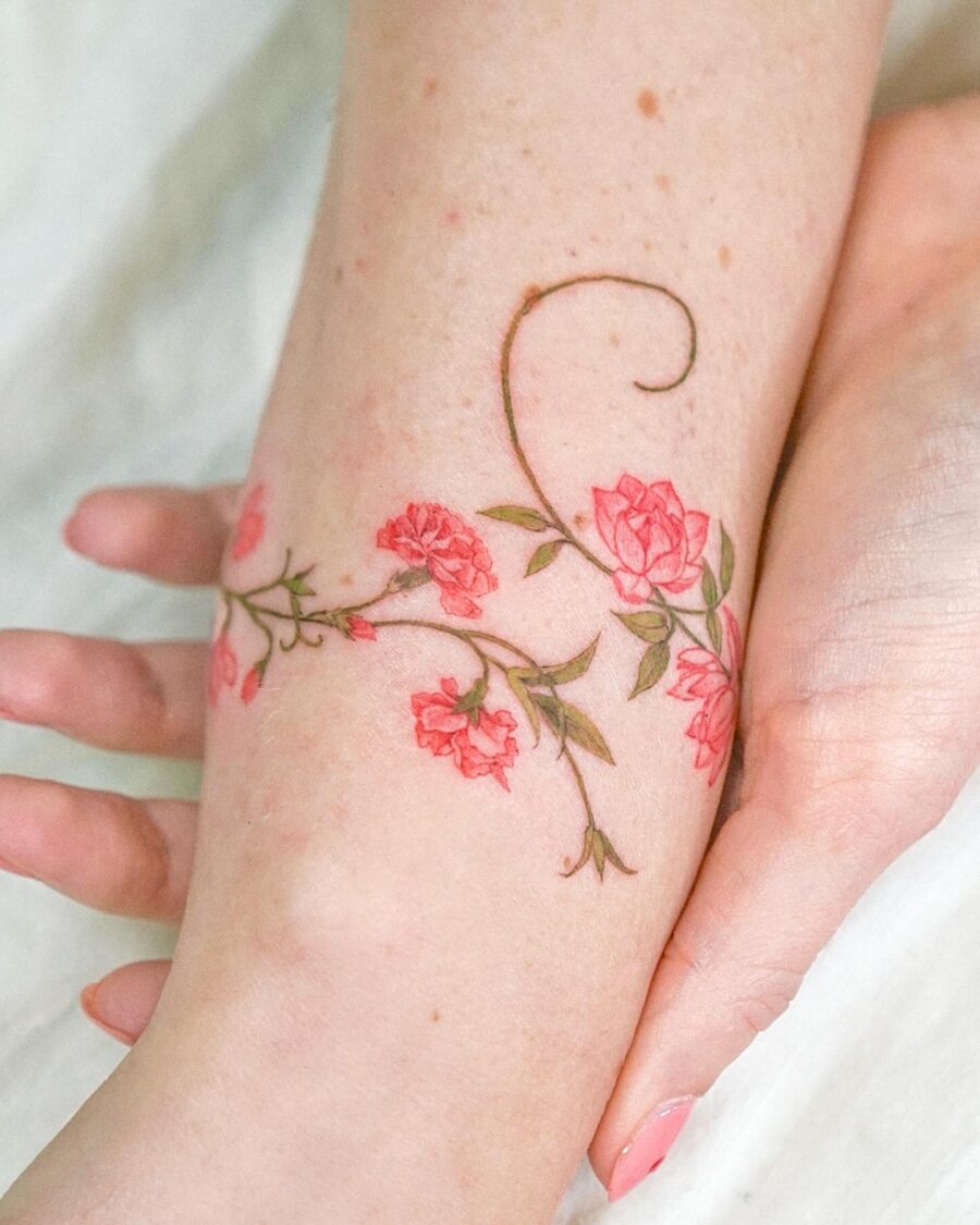 Delicate pink flower tattoo on arm Tattoo on skin