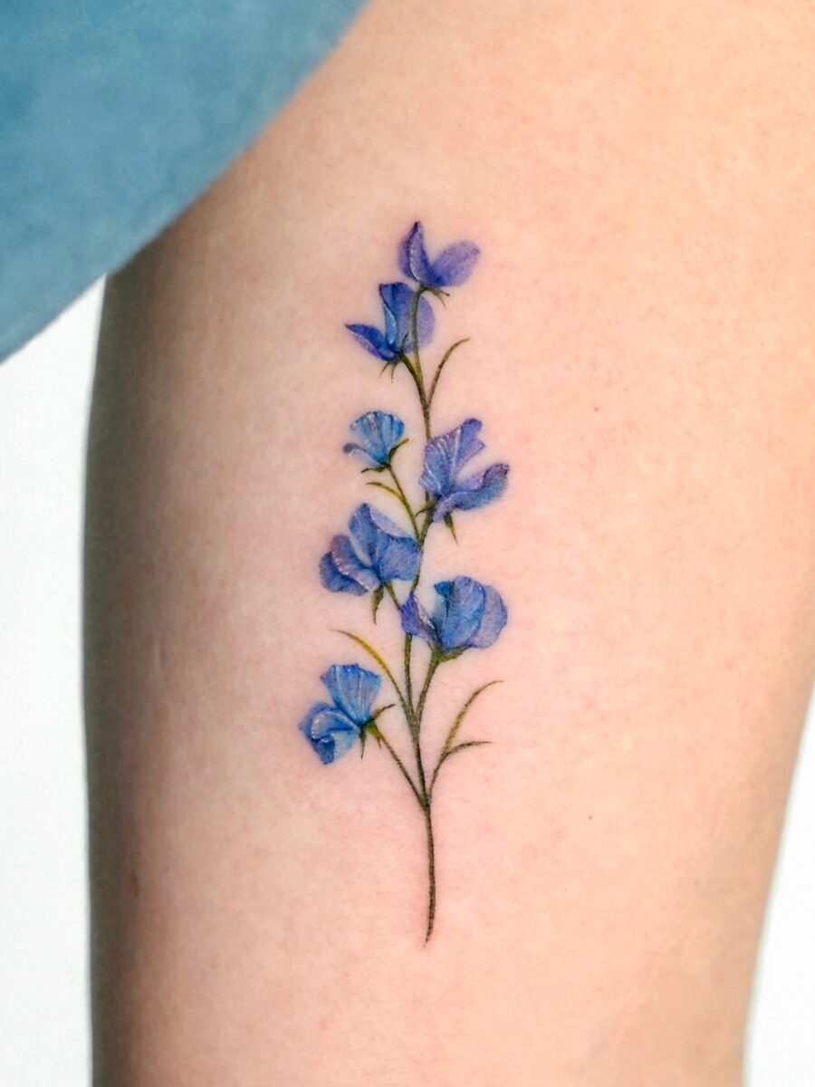 Elegant blue flower birth tattoo design on skin Tattoo on skin