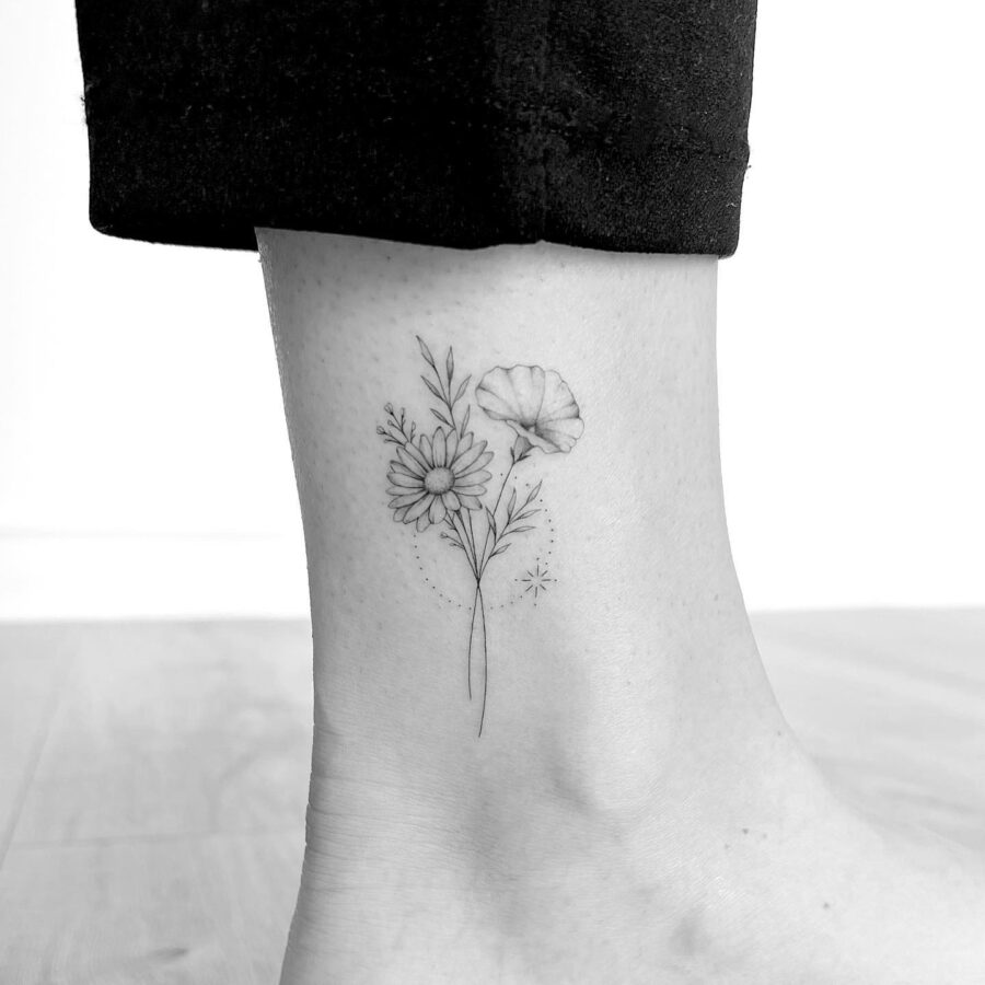 Elegant floral tattoo gracing the ankle Tattoo on skin