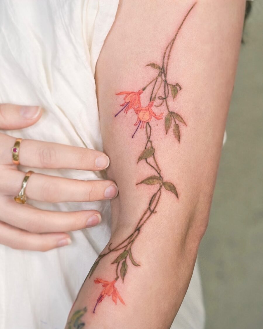 Elegant fuchsia flower tattoo on the arm Tattoo on skin