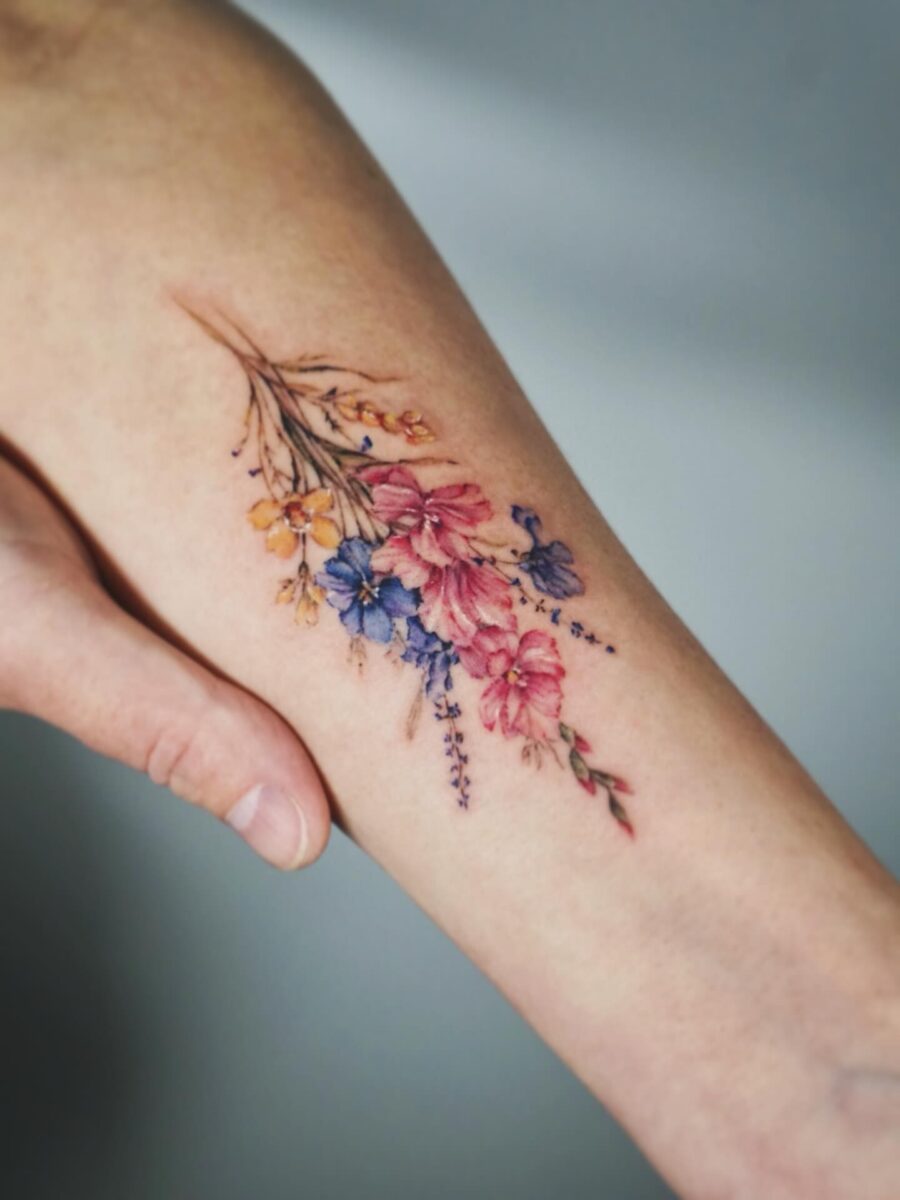 Stunning floral composition embraces the skin. Tattoo on skin