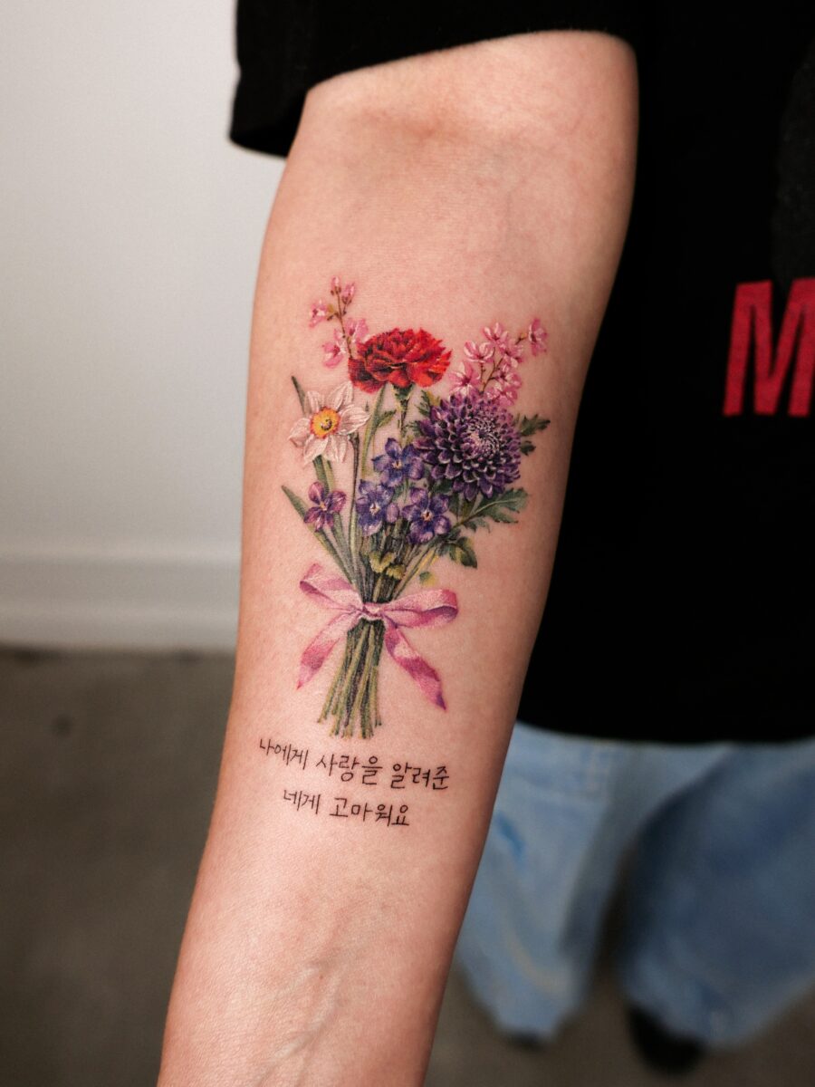 Vibrant floral bouquet tattoo with meaningful text Tattoo on skin
