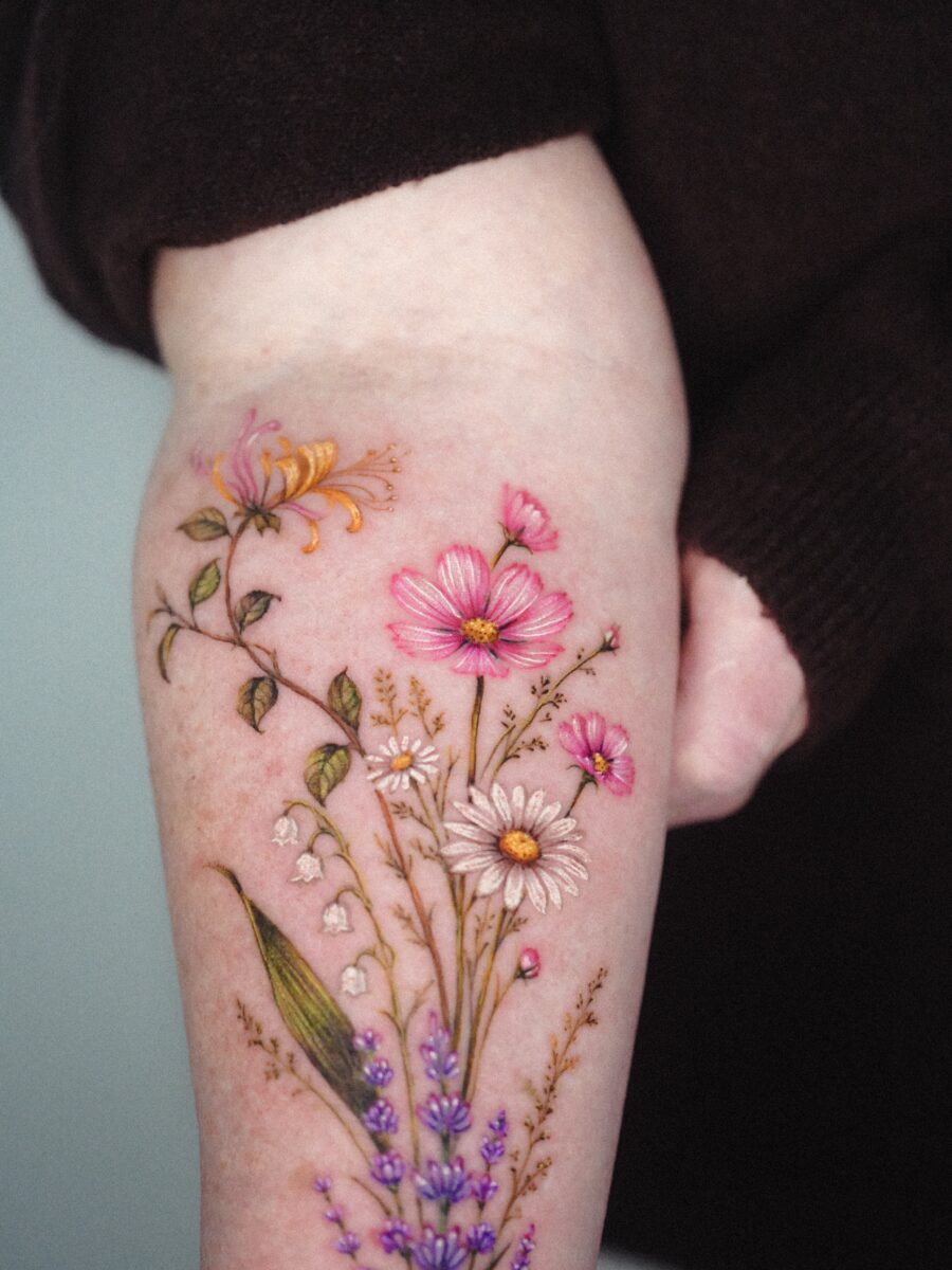 Vibrant floral tattoo showcasing birth flower meanings Tattoo on skin