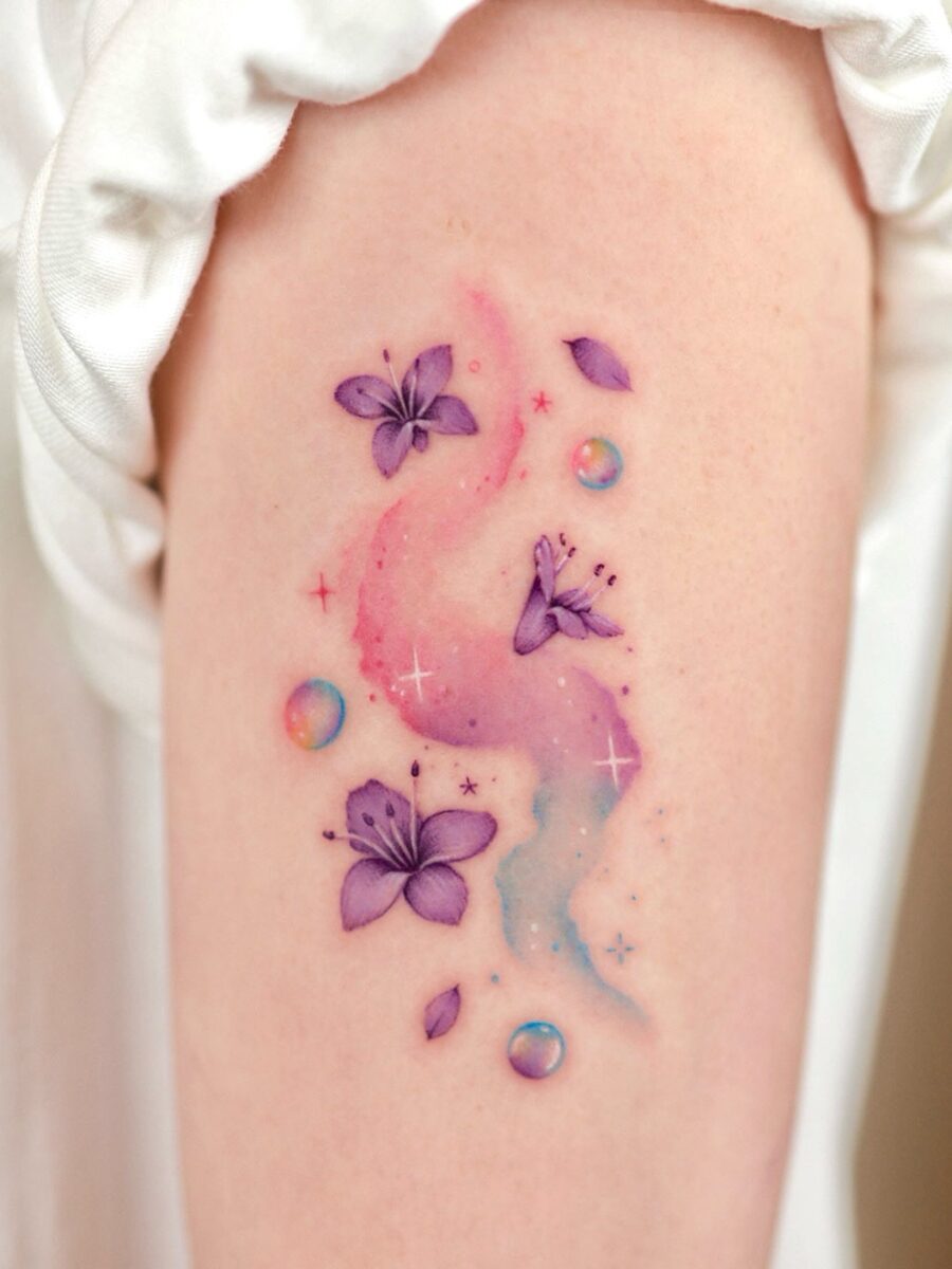 Whimsical Purple and Pink Flower Tattoo Design Tattoo on skin