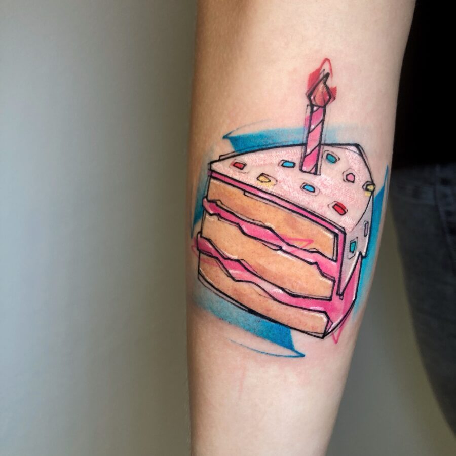 A colorful cake slice tattoo for birthdays Tattoo on skin
