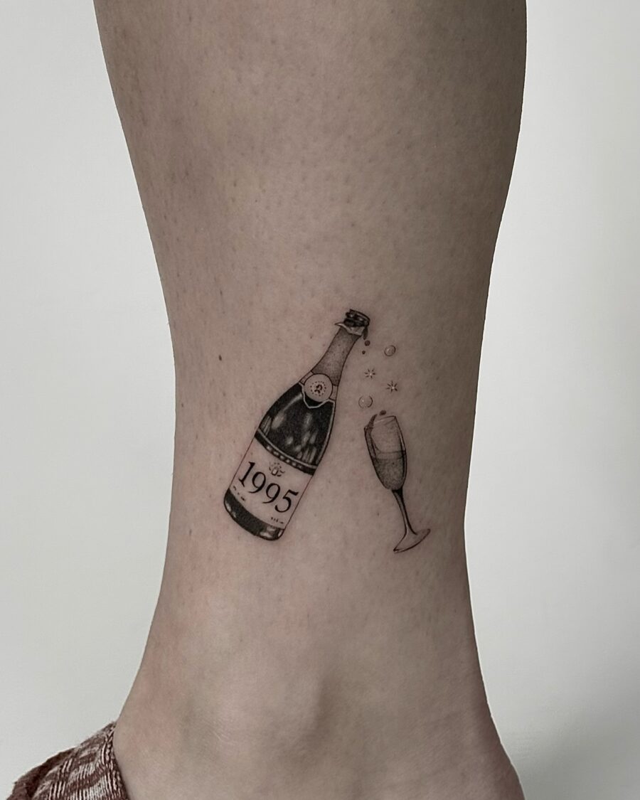 Celebrate with a charming 1995 champagne tattoo Tattoo on skin