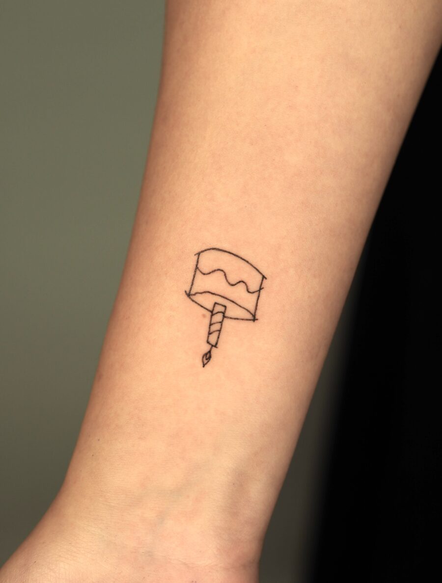 Delicate cake tattoo for joyful celebrations Tattoo on skin