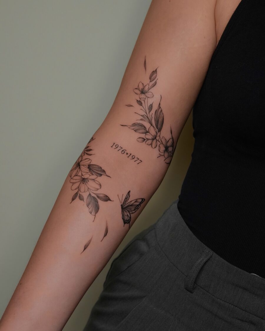 Floral-themed birthday tattoo with butterfly Tattoo on skin