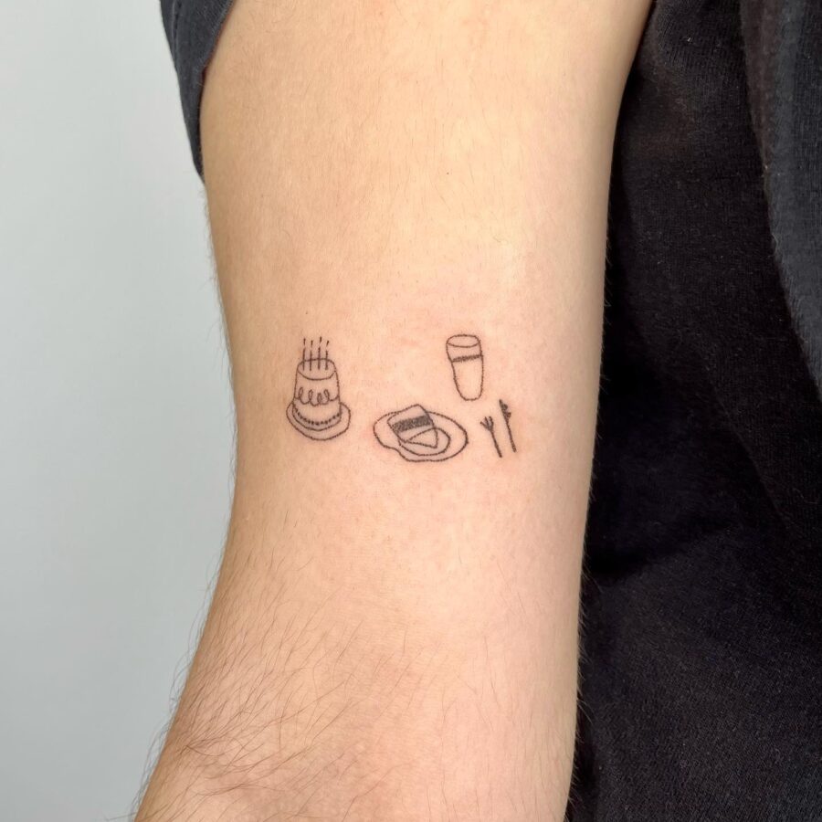 Minimalist birthday-themed tattoo design on arm Tattoo on skin