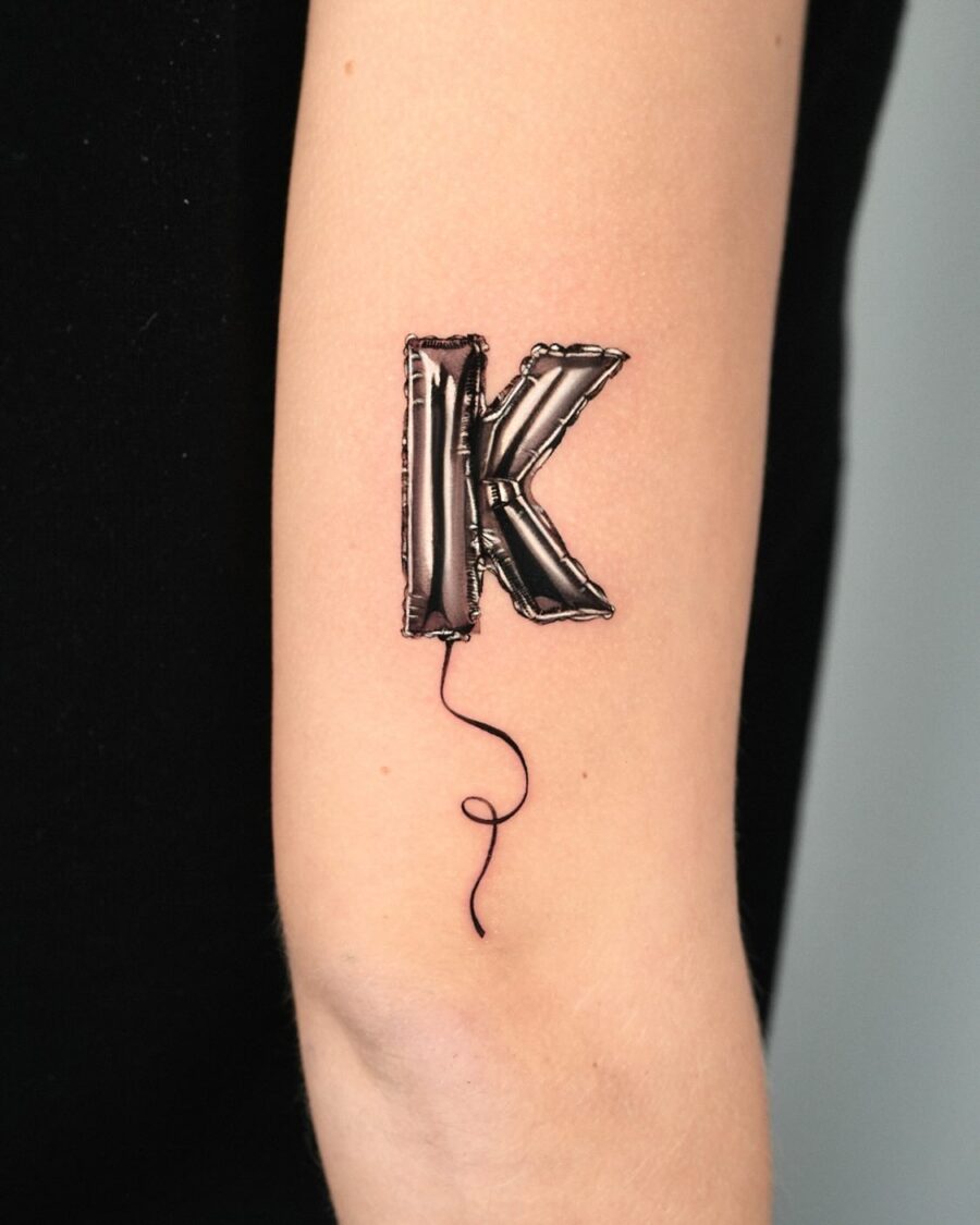 Playful balloon letter K tattoo design Tattoo on skin