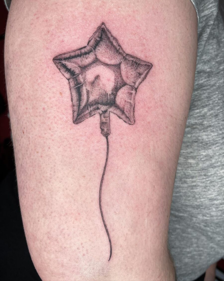Playful balloon tattoo symbolizing joyful celebrations Tattoo on skin