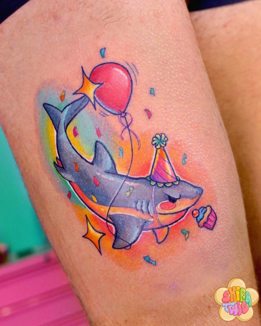 Playful shark with birthday vibes and color Tattoo on skin