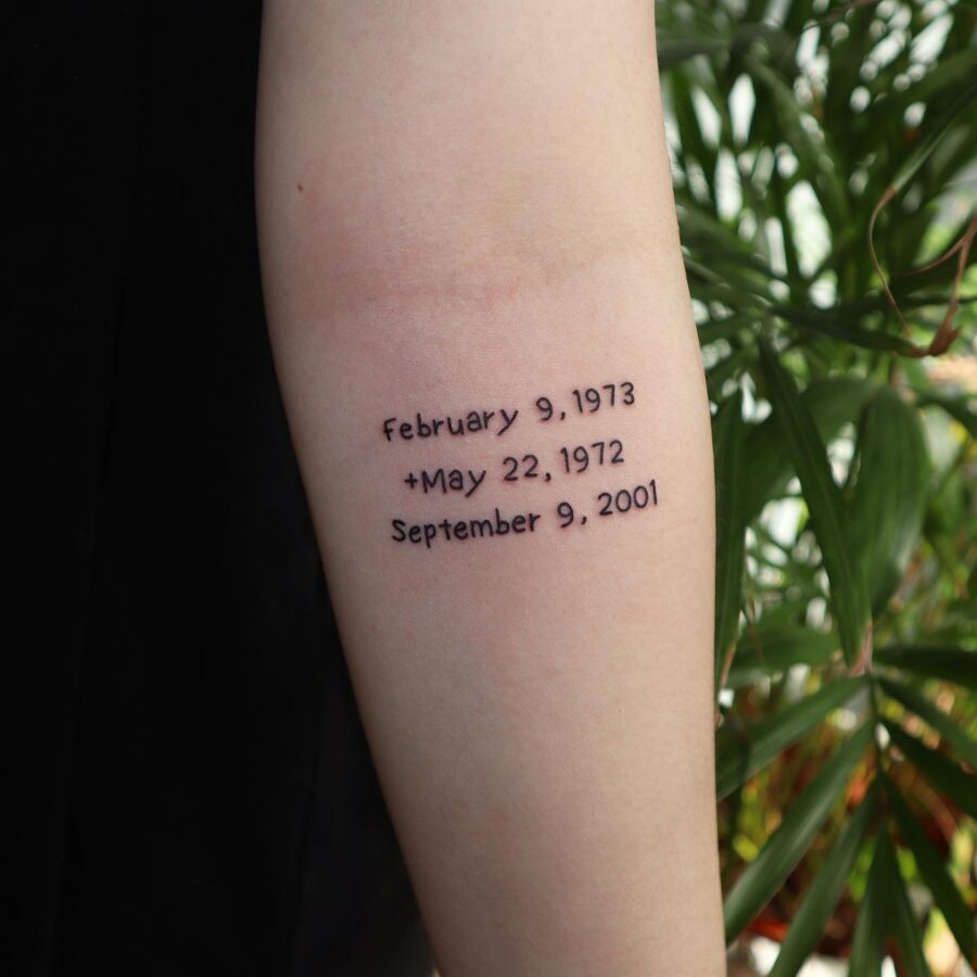 Significant dates inked in elegant script Tattoo on skin