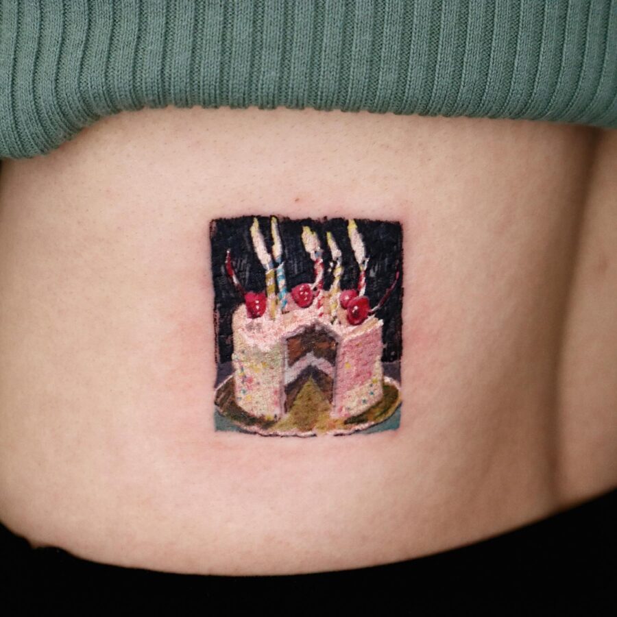 Vibrant Cake Tattoo Celebrating Special Moments Tattoo on skin