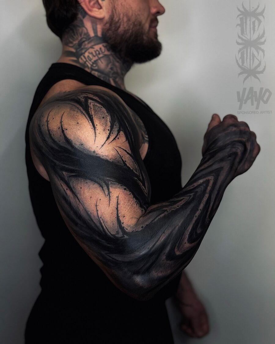 Bold and intricate black sleeve tattoo design Tattoo on skin