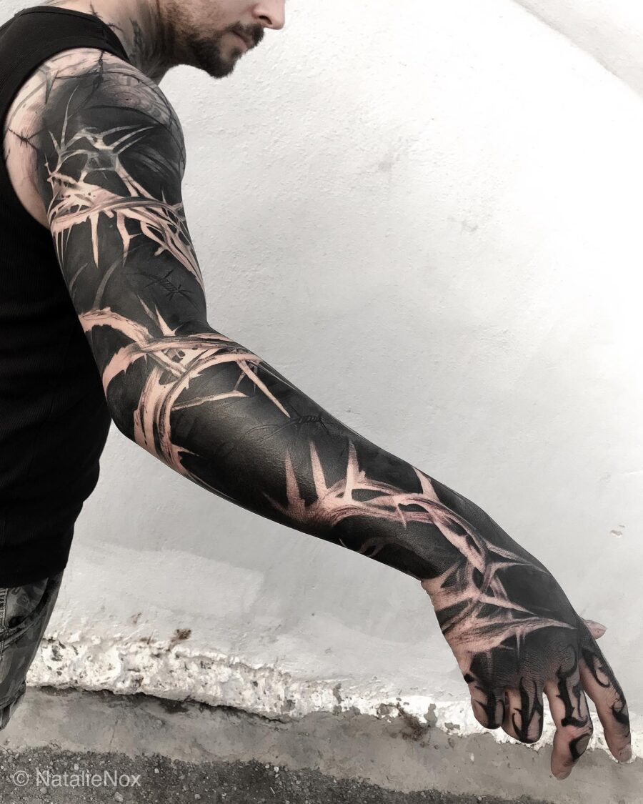Bold black bamboo-inspired sleeve tattoo design Tattoo on skin