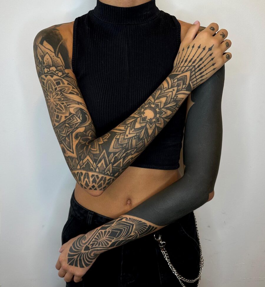 Dramatic black sleeve tattoo with intricate patterns Tattoo on skin