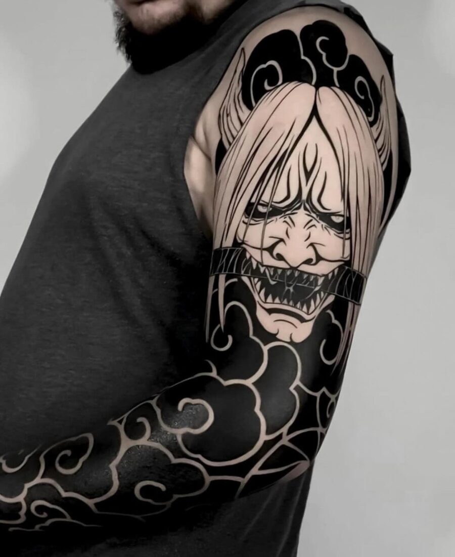 Dramatic character-inspired black sleeve tattoo Tattoo on skin
