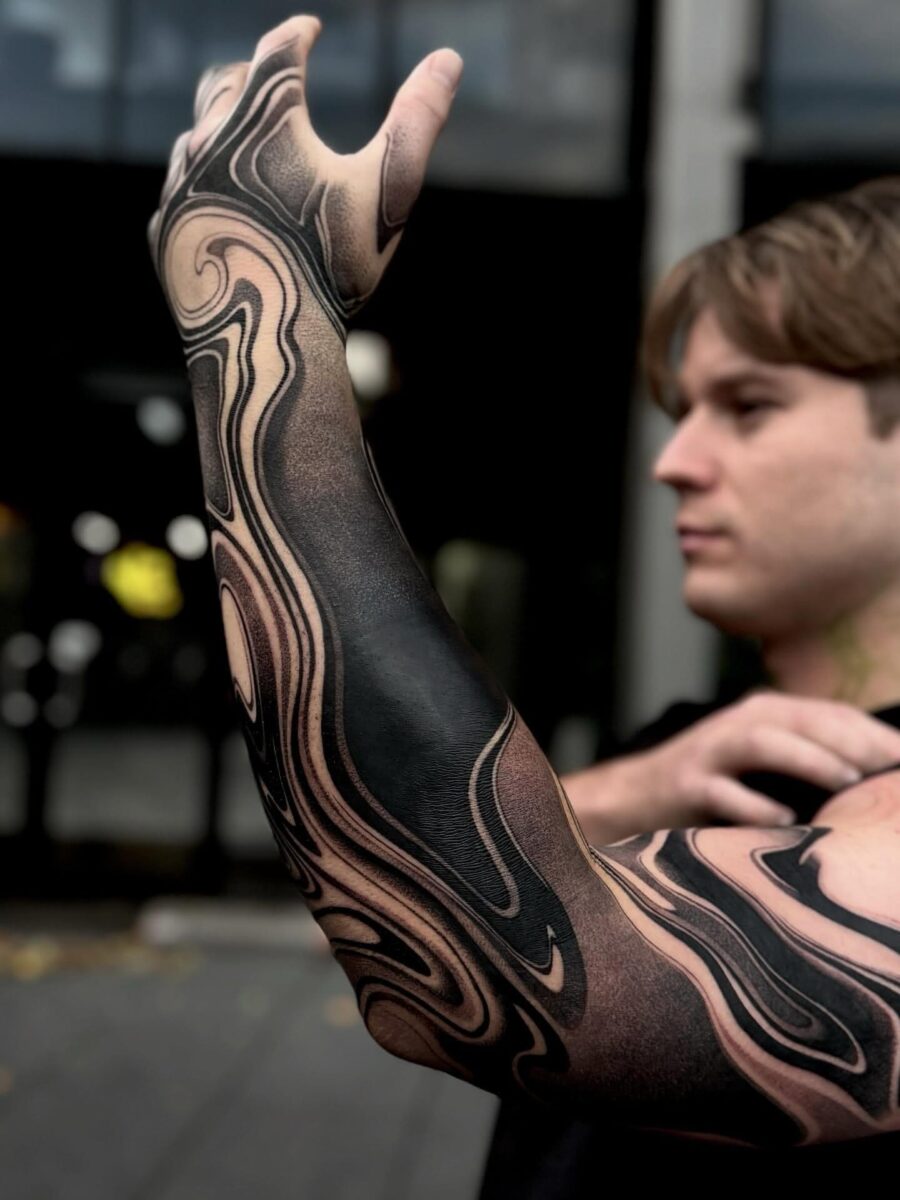 Dynamically swirling black sleeve tattoo design Tattoo on skin