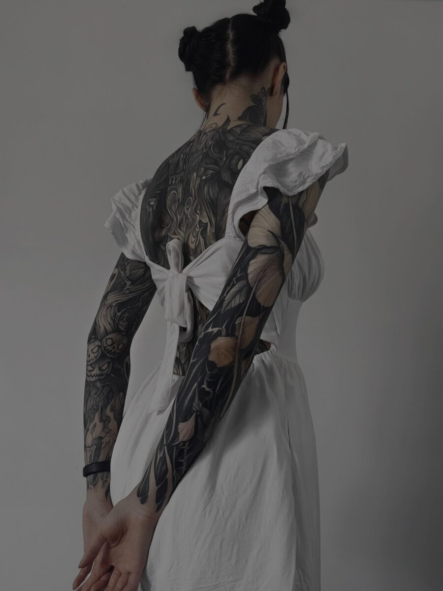 Elegant black sleeve tattoo with floral accents Tattoo on skin