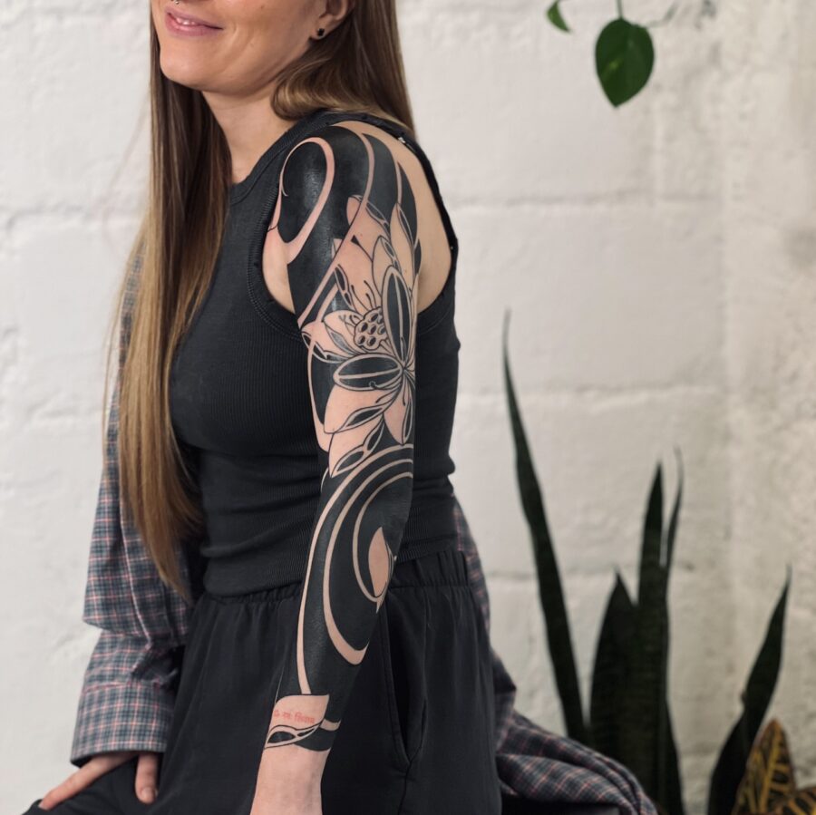 Elegant floral black sleeve tattoo on arm Tattoo on skin