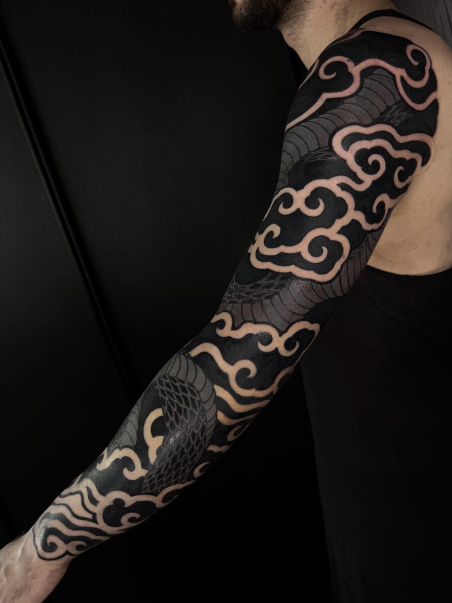 Elegant flow of clouds and waves Tattoo on skin