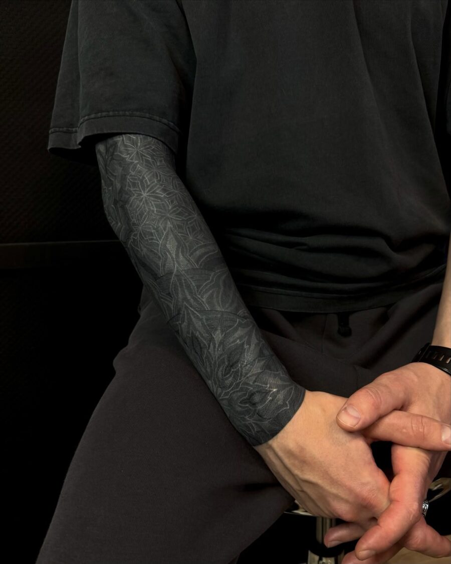 Intricate black sleeve tattoo design showcased elegantly Tattoo on skin