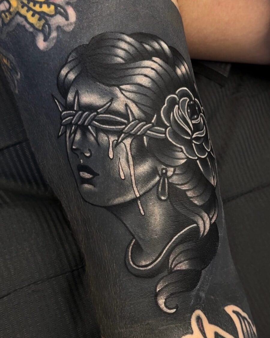 Intriguing blindfolded woman tattoo with rose Tattoo on skin