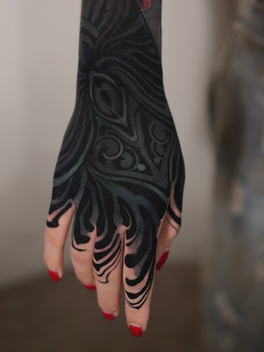 Stunning black sleeve tattoo on a hand Tattoo on skin