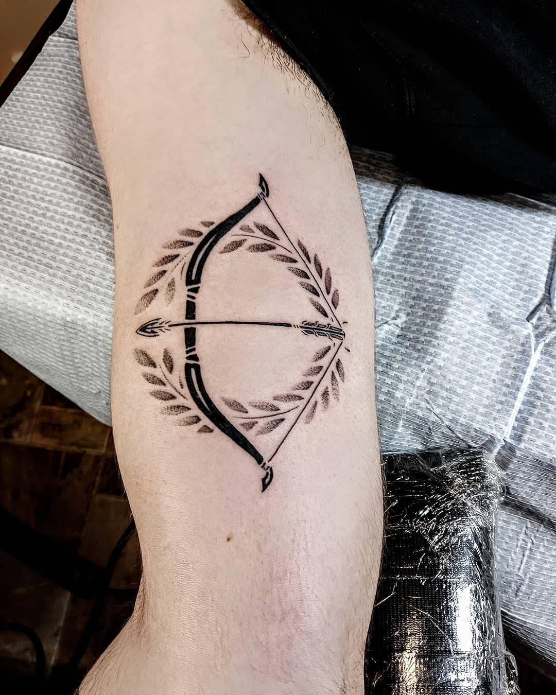 Greco Roman Style Tattoo Bow and Laurel Wreath Arrow Tattoo Tattoo on skin