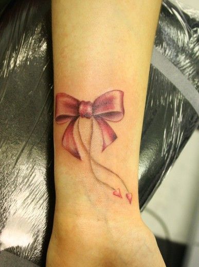 Pink bow awareness Tattoo on skin
