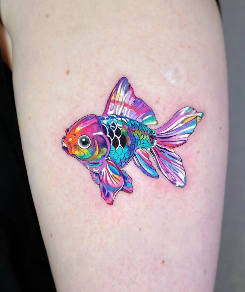 A mesmerizing goldfish tattoo bursting with color Tattoo on skin