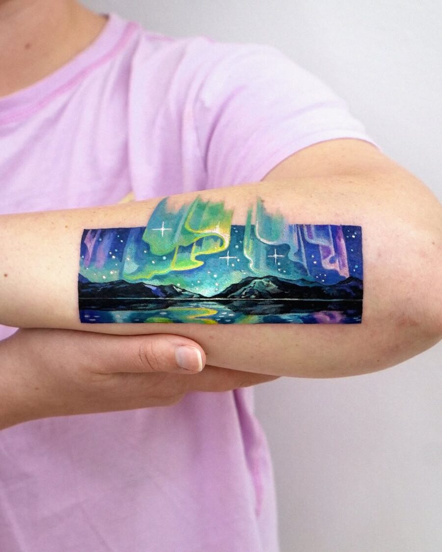 Captivating northern lights tattoo showcasing vibrant colors Tattoo on skin