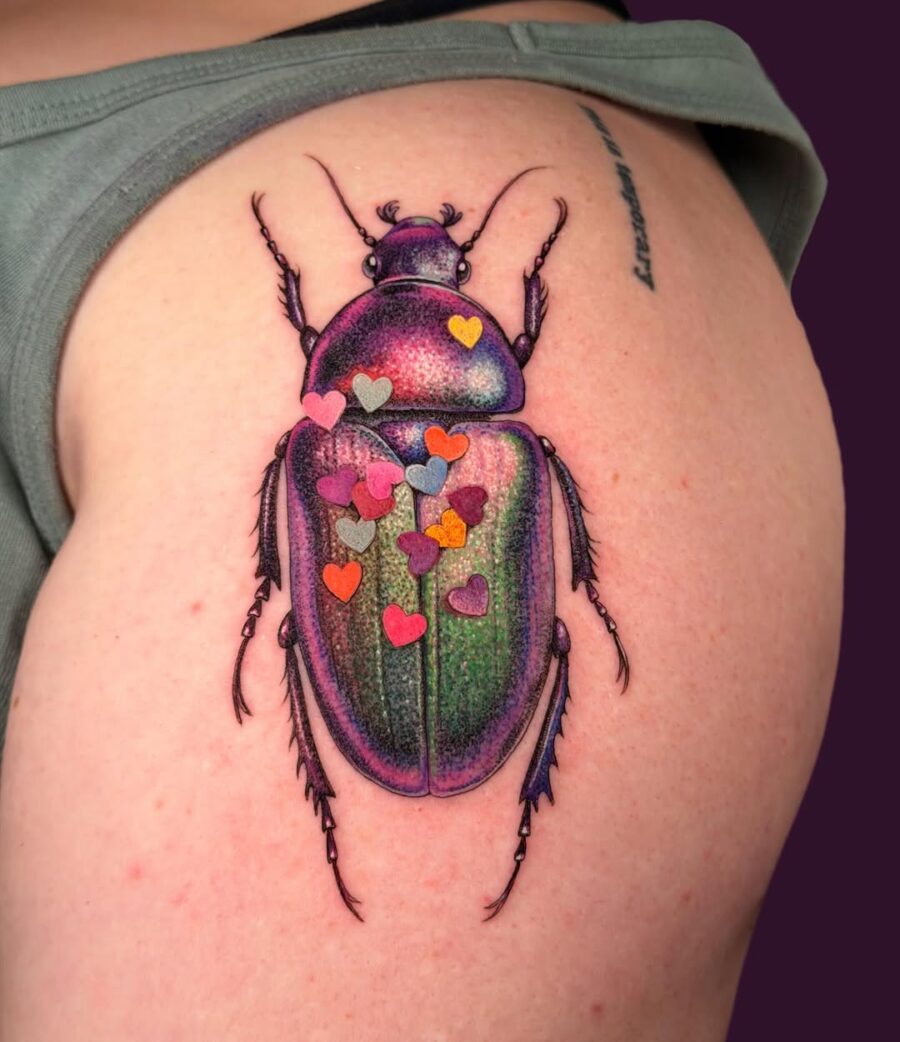 Colorful beetle tattoo adorned with hearts Tattoo on skin