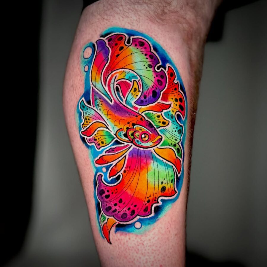 Radiant goldfish tattoo bursting with colors Tattoo on skin