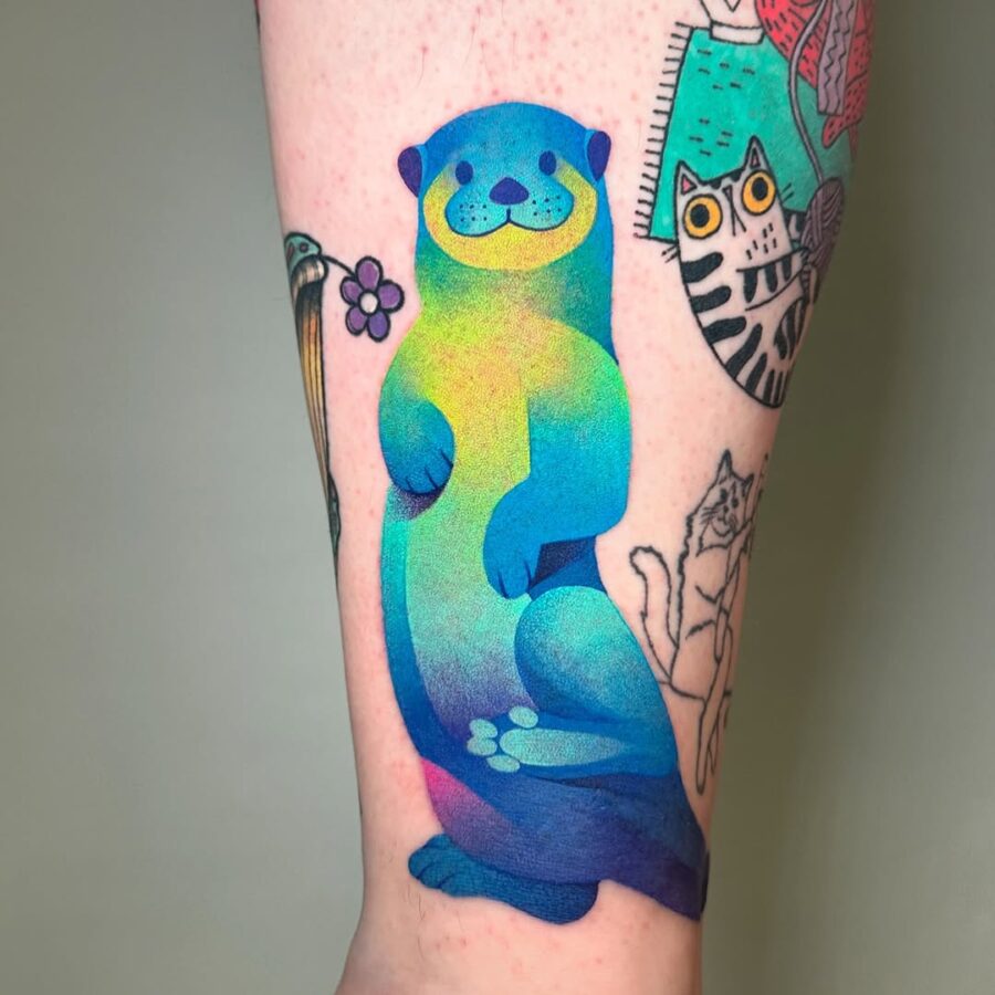Vibrant otter tattoo bursting with color Tattoo on skin