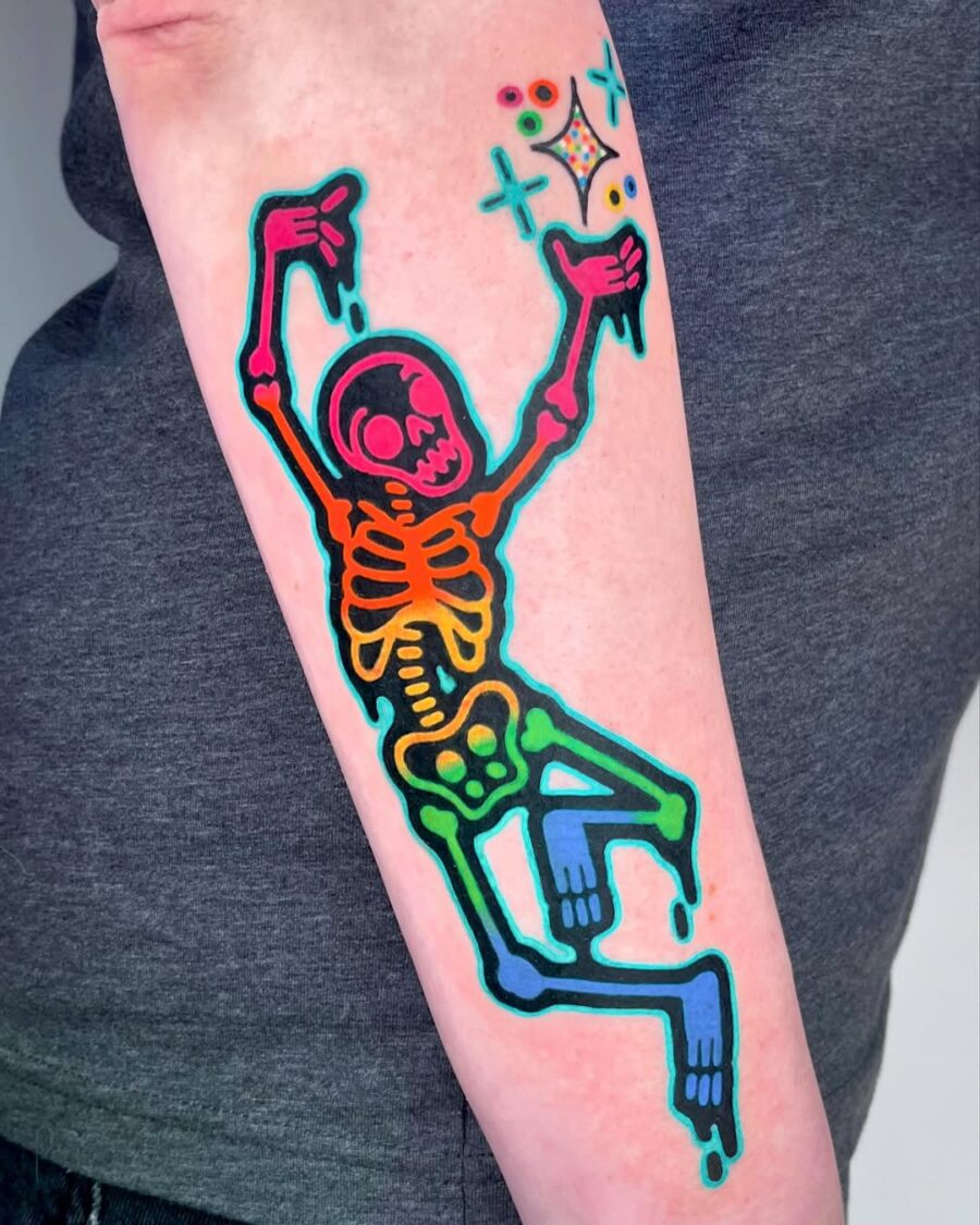 Vibrant Skeleton Dancing with Bright Colors Tattoo on skin