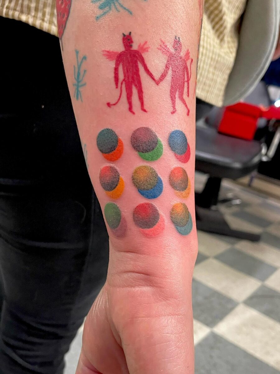 Vibrant tattoos showcasing playful characters and patterns Tattoo on skin