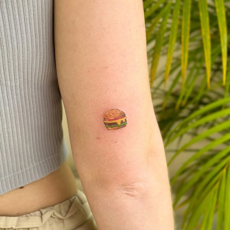 Charming small burger tattoo on the arm Tattoo on skin